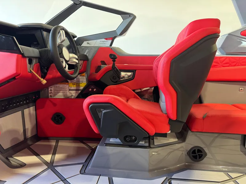 Slide: The Image of The image shows the interior of a 2027 Nautique Super Air Nautique G25 Paragon with red seats and a modern dashboard. - 25