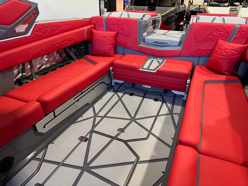 Slide: The Image of The image shows the interior of a 2027 Nautique Super Air Nautique G25 Paragon with red upholstery. - 17
