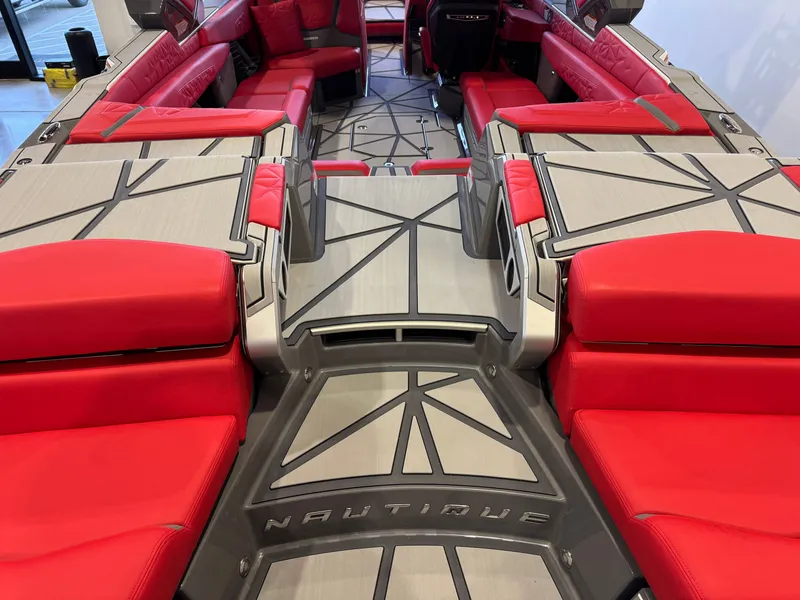 Slide: The Image of The image shows the interior of a 2027 Nautique Super Air Nautique G25 Paragon with red seating and modern design. - 9