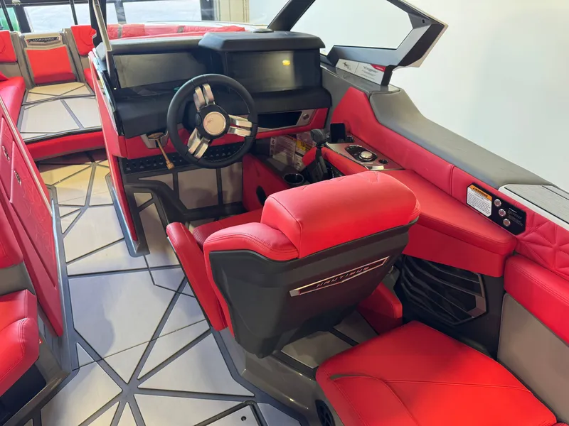 Slide: The Image of The image shows the cockpit of a 2027 Nautique Super Air Nautique G25 Paragon with red seats and a modern dashboard. - 27