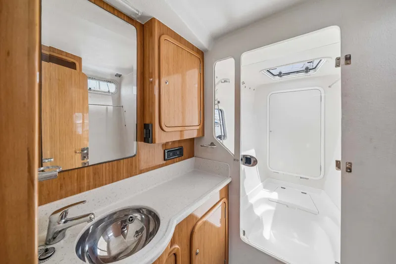 Slide: The Image of Compact boat bathroom with wooden cabinetry, stainless steel sink, and white countertop in St Francis SF 50. - 92