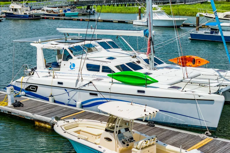 Slide: The Image of Catamaran St Francis SF 50, 2010 model, docked with kayaks on deck. - 15