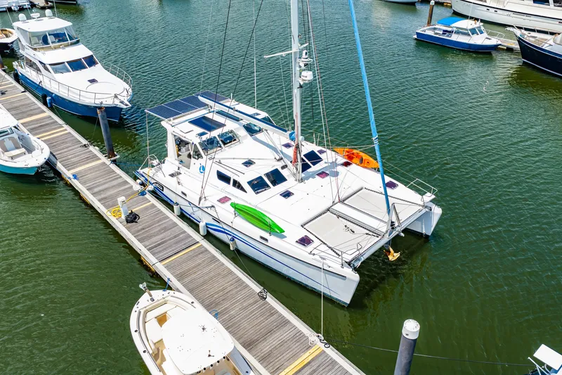 Slide: The Image of 2010 St Francis SF 50 catamaran docked at marina with kayaks on deck. - 16