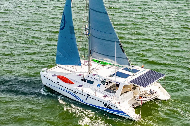 Slide: The Image of Sailing catamaran St Francis SF 50, 2010 model, with blue sails on open water. - 7