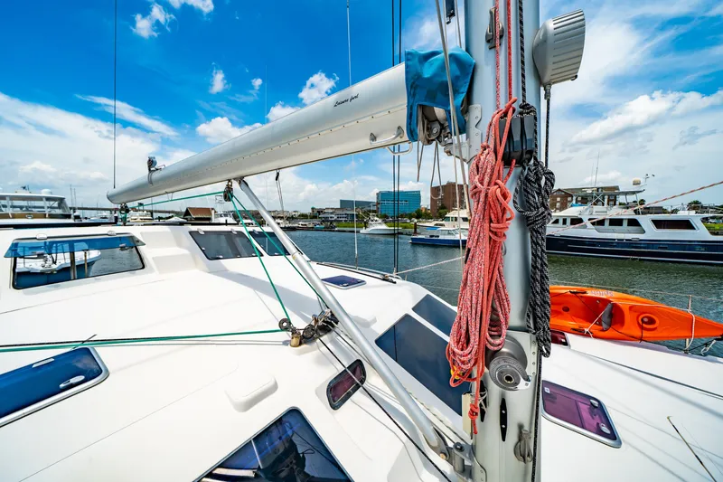 Slide: The Image of Sailing yacht St Francis SF 50, 2010 model, docked in a marina under a clear blue sky. - 61