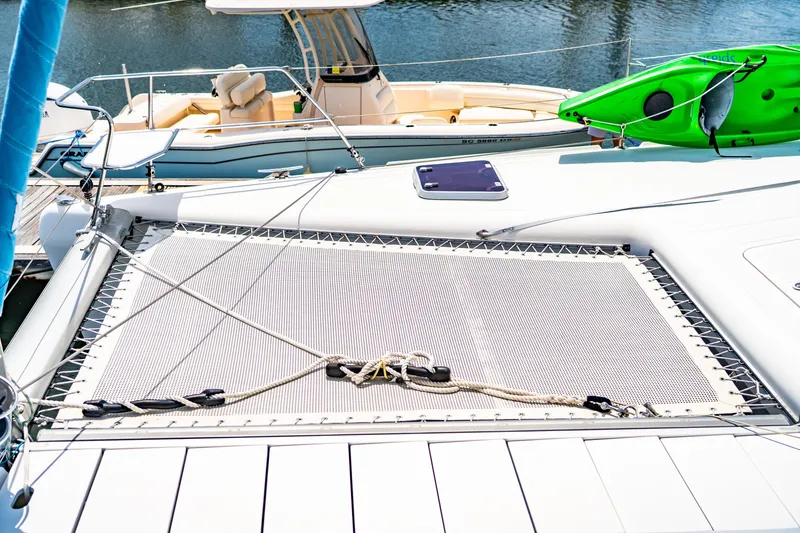 Slide: The Image of Catamaran deck with netting, featuring a green kayak, St Francis SF 50, 2010 model. - 27