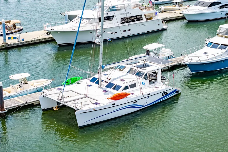 Slide: The Image of Catamaran St Francis SF 50, 2010 model, docked in a marina with other boats. - 17