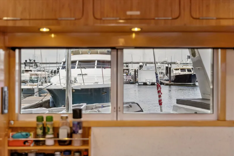 Slide: The Image of View from inside a 2010 St Francis SF 50 yacht, overlooking a marina with docked boats. - 74