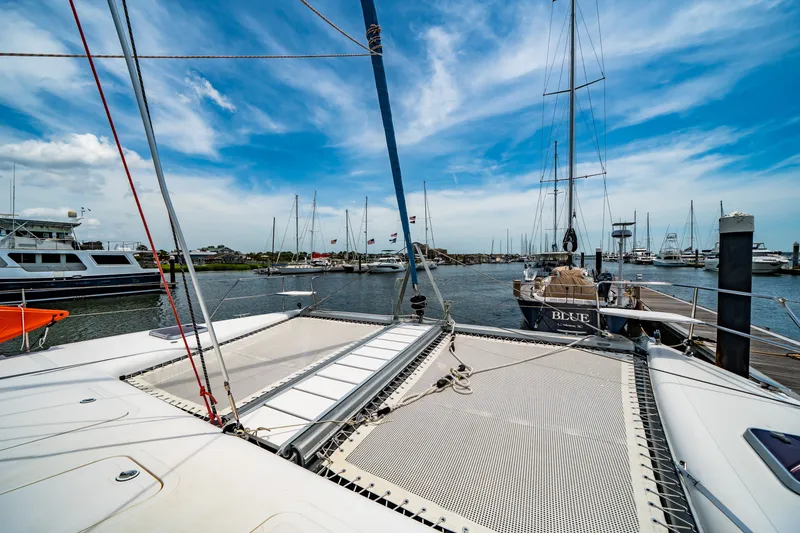 Slide: The Image of Catamaran St Francis SF 50, 2010 model, docked in a marina under a clear blue sky. - 29