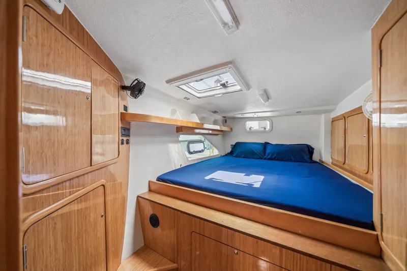 Slide: The Image of Luxurious cabin interior of 2010 St Francis SF 50 yacht with wooden finish and blue bedding. - 96