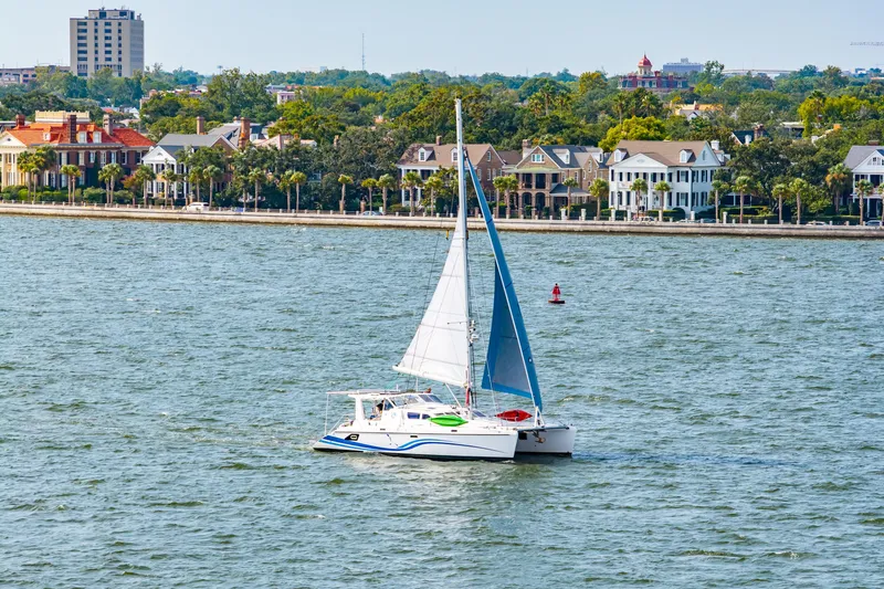 Slide: The Image of Sailboat St Francis SF 50 cruising near waterfront homes, 2010 model. - 1