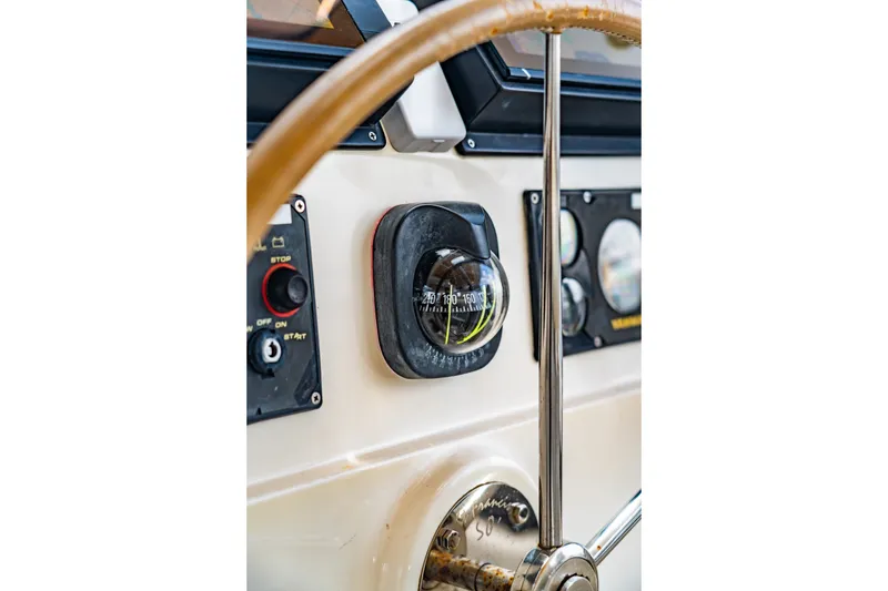 Slide: The Image of Steering wheel and compass on 2010 St Francis SF 50 boat dashboard. - 51