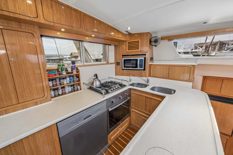 Slide: The Image of Modern yacht kitchen with wooden cabinets, stove, microwave, and sink on a St Francis SF 50, 2010. - 72