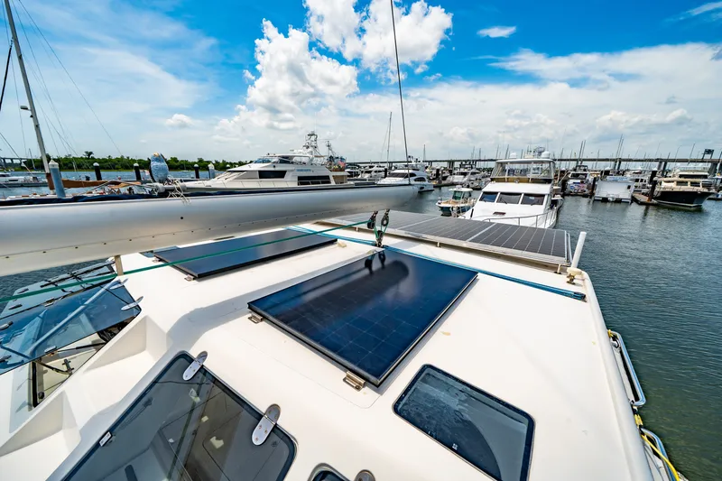 Slide: The Image of 2010 St Francis SF 50 yacht with solar panels docked at marina under blue sky. - 35