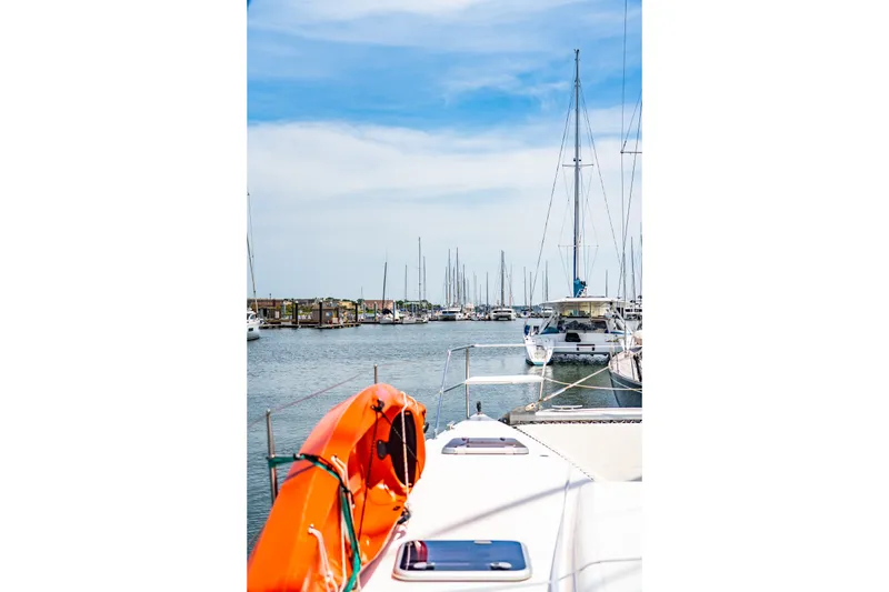 Slide: The Image of Sailboats docked in a marina, featuring a 2010 St Francis SF 50 catamaran. - 64