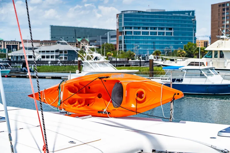 Slide: The Image of Orange kayak on St Francis SF 50 yacht, docked in urban marina, 2010 model. - 60