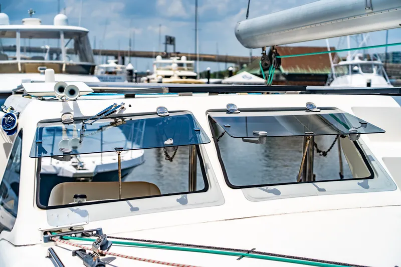 Slide: The Image of 2010 St Francis SF 50 yacht with open windows, docked in a marina under a clear sky. - 34