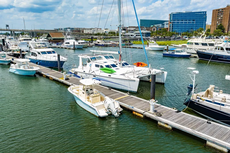 Slide: The Image of Marina with various boats, featuring a 2010 St Francis SF 50 catamaran docked. - 14