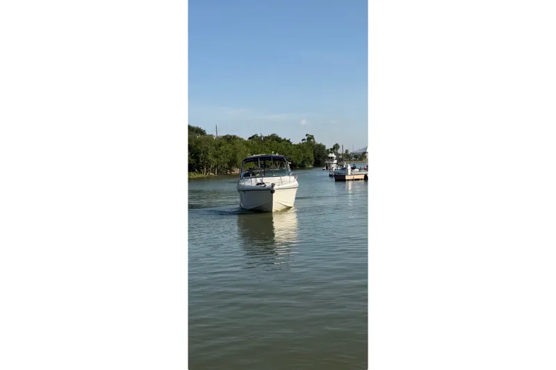 Slide: The Image of 2003 Formula 330 Sun Sport boat cruising on a calm river. - 3