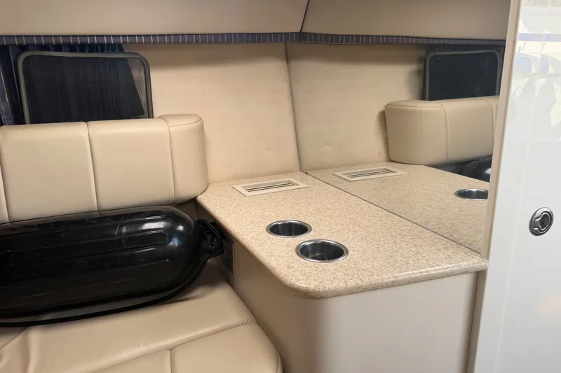 Slide: The Image of Interior of a 2003 Formula 330 Sun Sport boat with beige seating and a countertop. - 29
