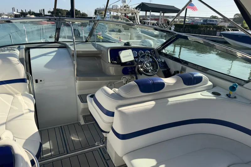 Slide: The Image of 2003 Formula 330 Sun Sport boat interior with plush seating and modern dashboard. - 12