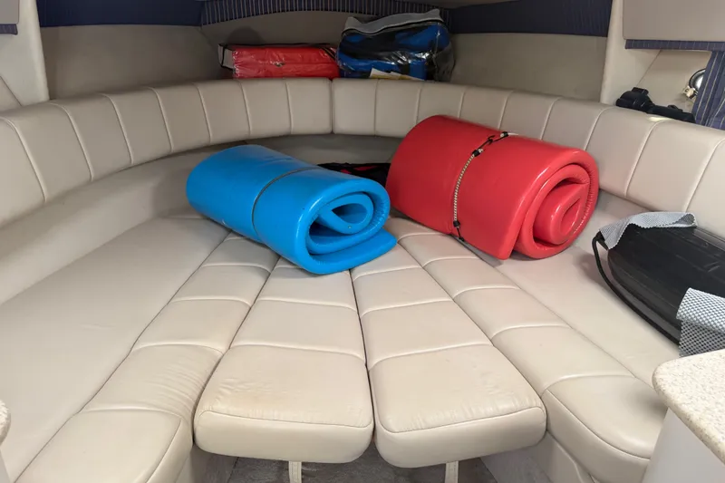 Slide: The Image of Interior of 2003 Formula 330 Sun Sport boat with rolled mats on beige seating. - 28
