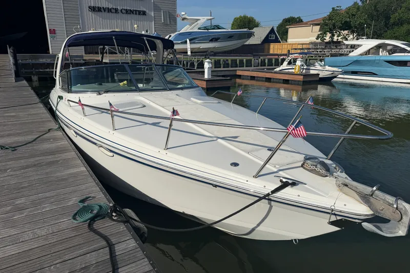 Slide: The Image of 2003 Formula 330 Sun Sport docked at marina, featuring sleek design and American flags. - 7