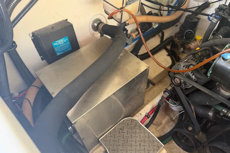 Slide: The Image of Engine compartment of a 2003 Formula 330 Sun Sport boat, showcasing mechanical components and wiring. - 39