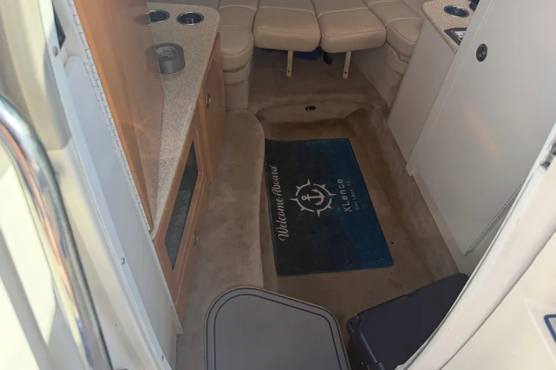 Slide: The Image of Interior of a 2003 Formula 330 Sun Sport boat with seating and a welcome mat. - 26