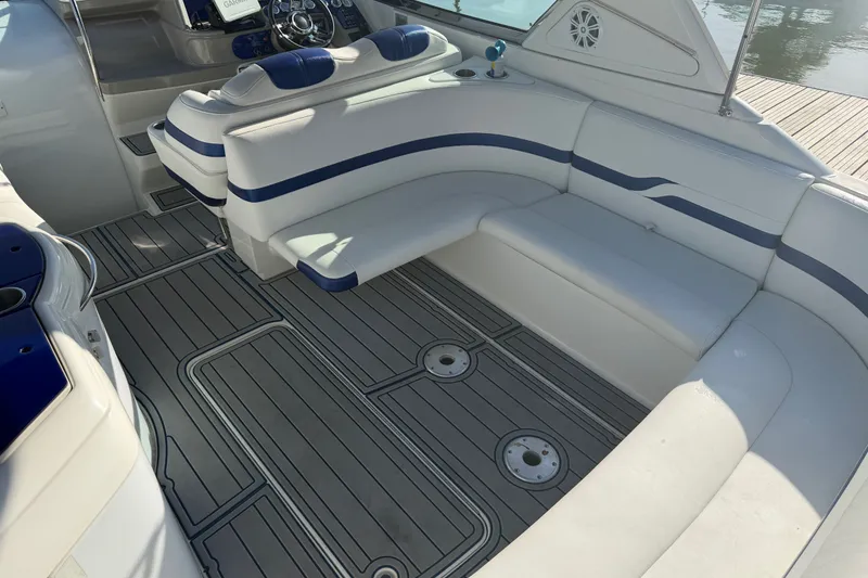Slide: The Image of 2003 Formula 330 Sun Sport boat interior with white and blue seating, sleek design. - 13