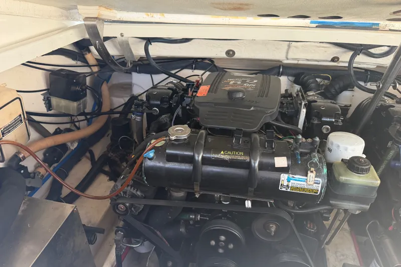 Slide: The Image of Engine compartment of a 2003 Formula 330 Sun Sport boat, showcasing mechanical components. - 37