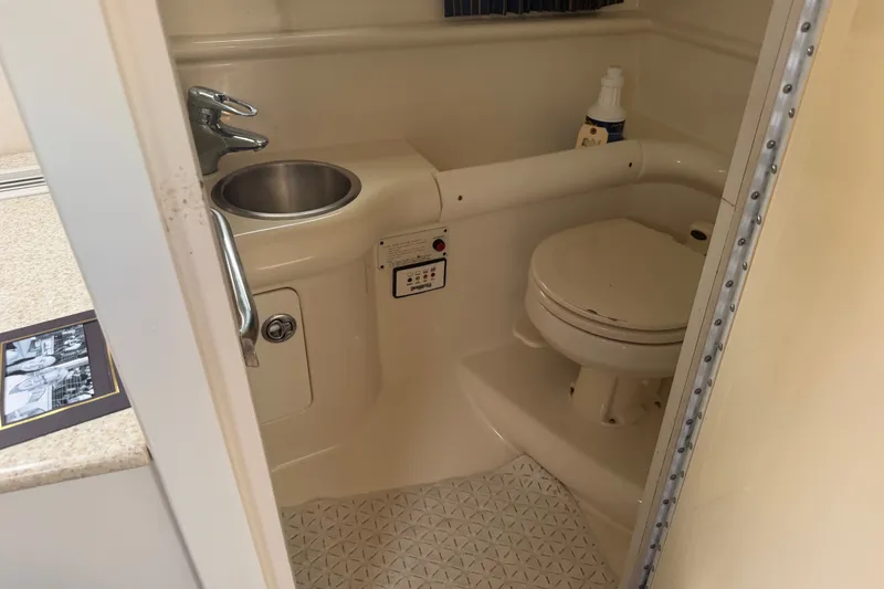 Slide: The Image of Compact bathroom in 2003 Formula 330 Sun Sport boat with sink and toilet. - 34