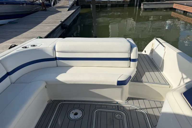 Slide: The Image of 2003 Formula 330 Sun Sport boat interior with white and blue seating at a marina. - 11