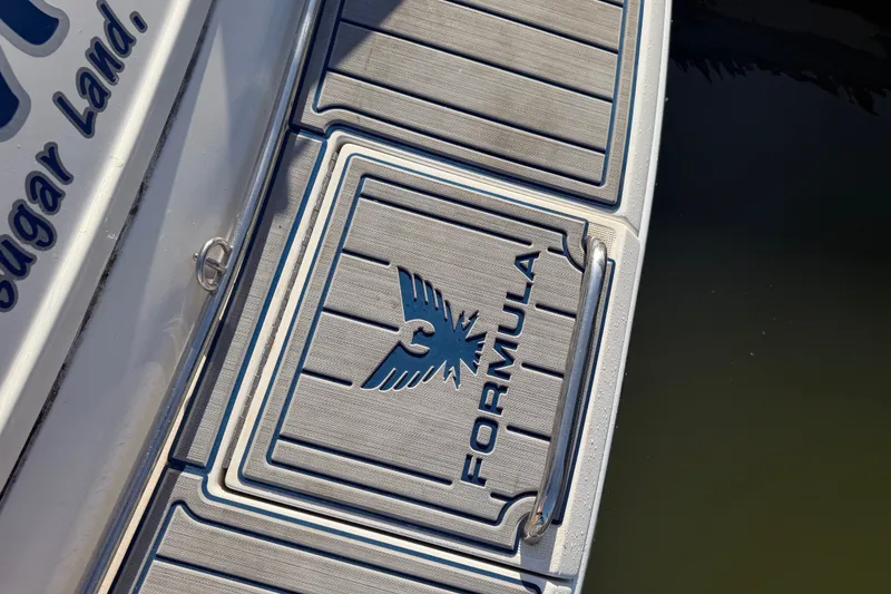 Slide: The Image of 2003 Formula 330 Sun Sport boat deck with logo and branding. - 8