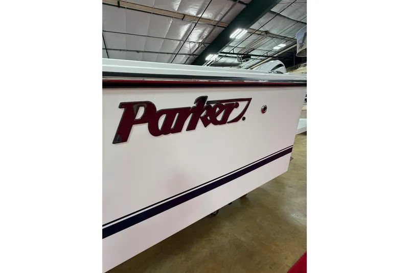 Slide: The Image of Side view of a 2027 Parker 240 Coastal Elite boat in a showroom. - 7