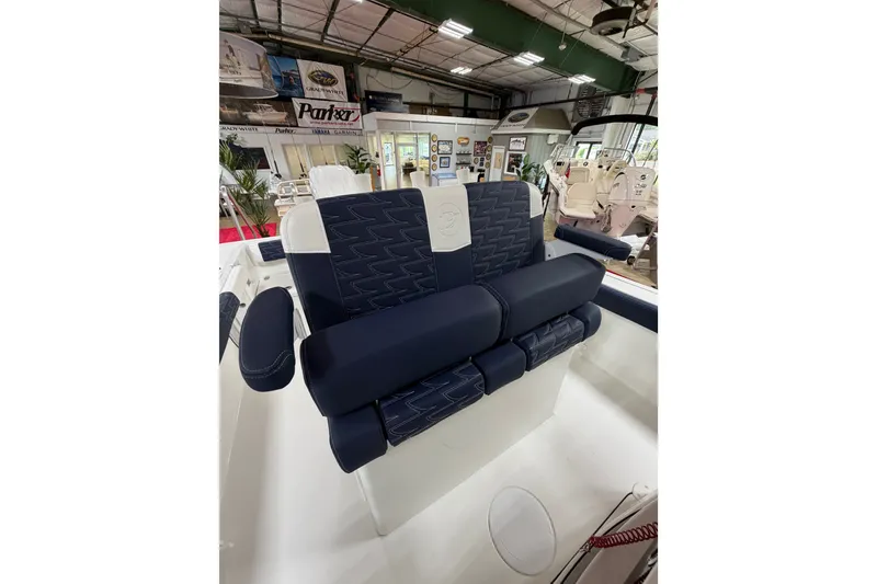 Slide: The Image of Luxury seating on a 2027 Parker 240 Coastal Elite boat, showcased indoors. - 12
