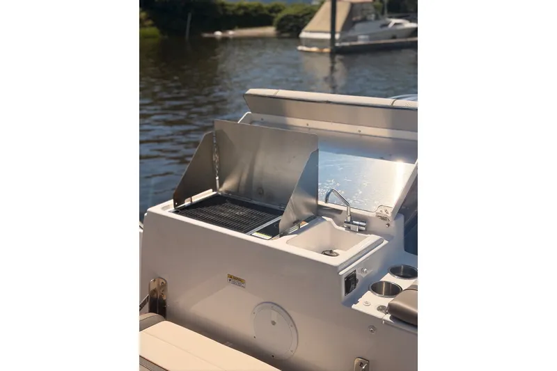 Slide: The Image of Outdoor kitchen on 2022 Cutwater C-24 Coupe boat with grill and sink. - 4
