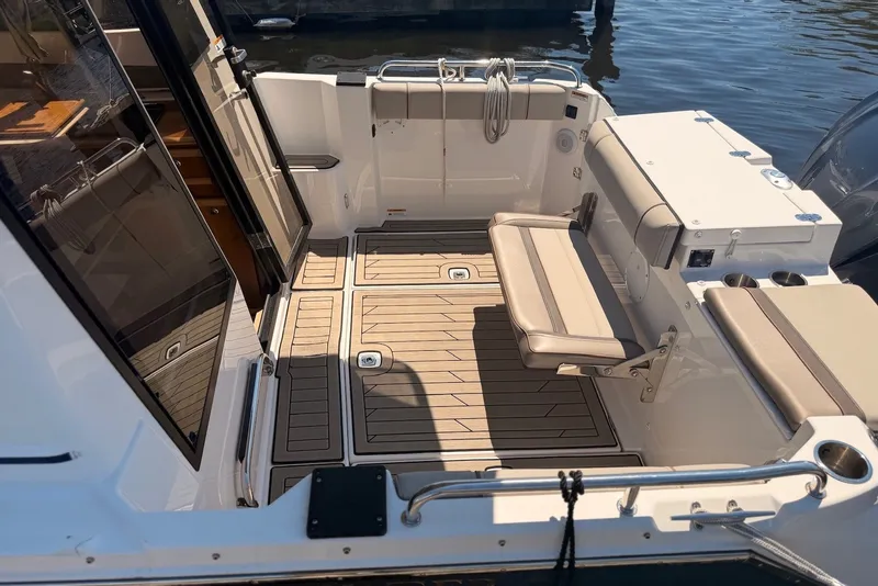 Slide: The Image of 2022 Cutwater C-24 Coupe boat interior with seating and teak flooring. - 2
