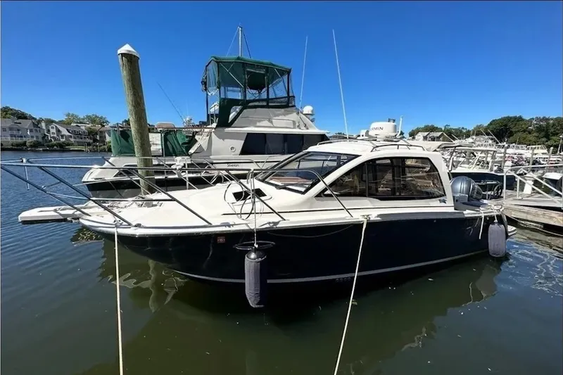 The Image of 2022 Cutwater C-24 Coupe docked at marina, sleek design, sunny day. - 0