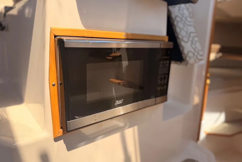 Slide: The Image of Built-in microwave in 2022 Cutwater C-24 Coupe boat interior. - 11