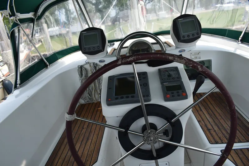 Slide: The Image of Cockpit of 1999 Beneteau Oceanis 36 CC sailboat with navigation instruments and steering wheel. - 18