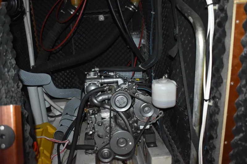 Slide: The Image of Engine compartment of a 1999 Beneteau Oceanis 36 CC sailboat, showcasing mechanical components. - 49