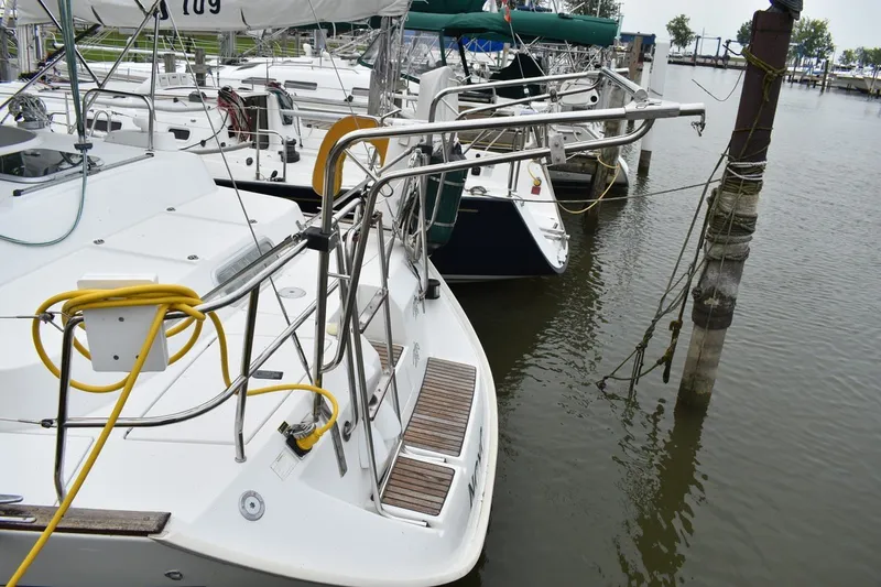 Slide: The Image of 1999 Beneteau Oceanis 36 CC sailboat docked at marina, rear view. - 7