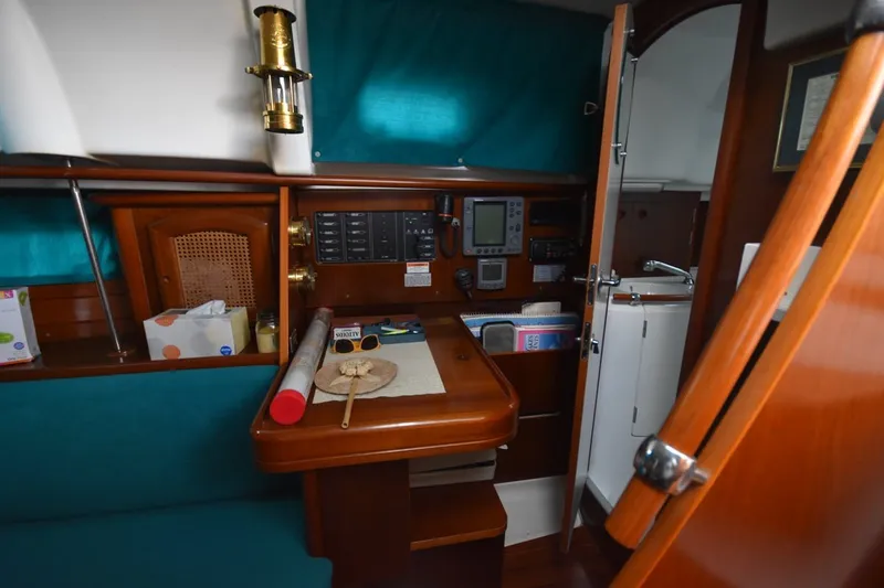 Slide: The Image of Interior of 1999 Beneteau Oceanis 36 CC sailboat with navigation equipment and wooden cabinetry. - 40