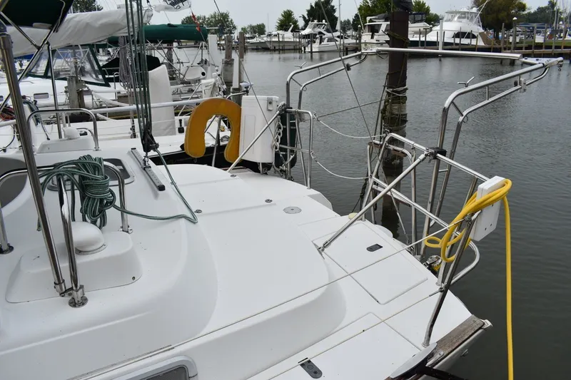 Slide: The Image of 1999 Beneteau Oceanis 36 CC sailboat docked, featuring deck details and marina background. - 6