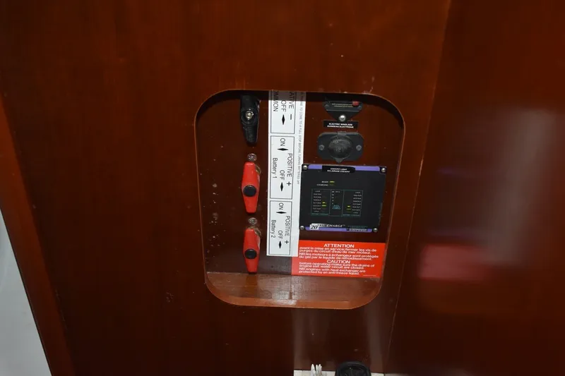 Slide: The Image of Electrical panel on a 1999 Beneteau Oceanis 36 CC sailboat, featuring battery switches and controls. - 48