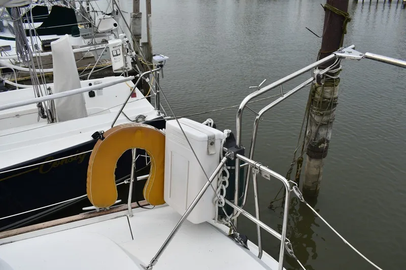 Slide: The Image of Beneteau Oceanis 36 CC sailboat docked, featuring safety equipment and railing, 1999 model. - 12