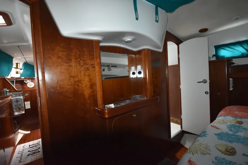 Slide: The Image of Interior of 1999 Beneteau Oceanis 36 CC sailboat with wood finish and cozy cabin. - 36
