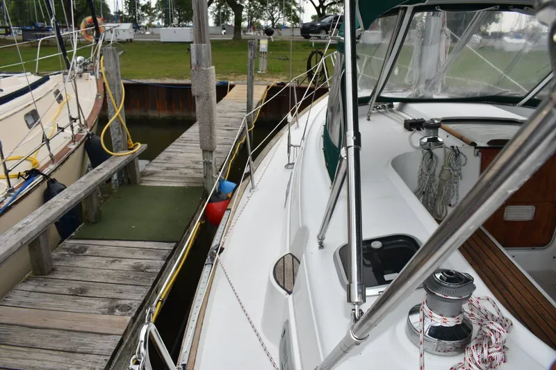 Slide: The Image of 1999 Beneteau Oceanis 36 CC sailboat docked at a marina, showcasing deck and winch. - 15