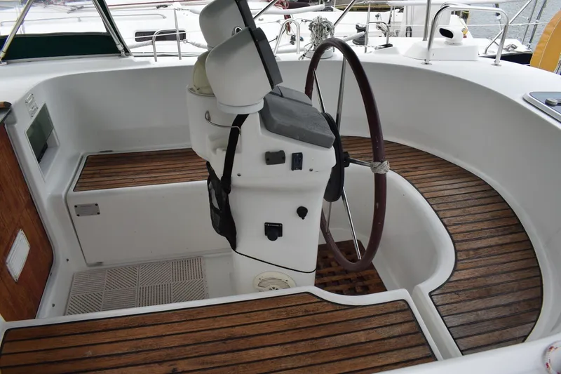 Slide: The Image of Cockpit of 1999 Beneteau Oceanis 36 CC sailboat with wooden flooring and steering wheel. - 10